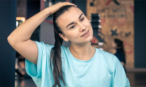 Portrait of fitness woman stretching at gym before workout