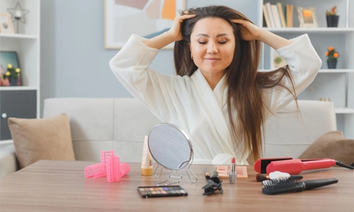 Woman massaging her scalp while discussing common myths about hair growth