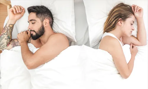 Couple sleeping peacefully in bed