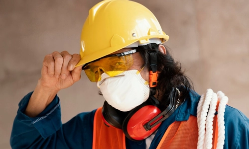 Construction worker wearing modern safety equipment and protective headgear