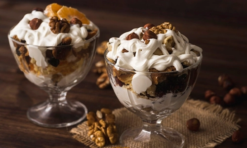 Close-up image of Scoop of ice cream topped with rich chocolate syrup