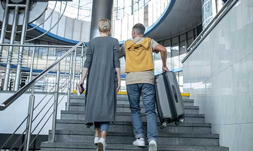 Why are There so Few Escalators in Wyoming? Image - https://www.freepik.com/free-photo/two-airline-passengers-with-travel-documents-baggage-going-upstairs_22337889.htm The state is full of multi-story buildings. Then why does Wyoming still not want its citizens to take advantage of the escalators? When a spokesman of the Wyoming Governor’s office was asked if the count of escalators had increased since 2008, he was unsure about it. Many people also claimed that most of the buildings including hospitals and airports do not have escalators. Instead, most of the public buildings had elevators and stairs. Which Escalator was Demolished in Wyoming? Dick Mason in the Cheyenne building office explained that Cheyenne, the state’s capital and its most populous city, did not have any escalators. Once, the J.C. Penny building had an escalator, but when the building was demolished, the escalator was also gone. People who live over there most often use stairs and elevators. He also explained the several reasons behind the lack of escalators. One of the major reasons he explained was the code issue involved with escalators. Is There a Story Behind Wyoming's Escalators? Image - https://assets.simpleviewinc.com/simpleview/image/upload/c_fill,h_715,q_75,w_1075/v1/crm/casper/Casper-Natrona-County-International-Airport-8-_005E728E-5056-A36A-0ACC24AE971D146F-005e6fe55056a36_005e72e7-5056-a36a-0a65e7effc082a8e.jpg Though it may seem amusing to ask, the reality is that, with a population of 585,501, this state only has two escalators. This scarcity is attributed to low occupancy and legal policies. The code issue is what made the escalators less popular. In stairways, people can find enclosed ways to escape buildings, but escalators usually do not provide that opportunity. Most of the engineers do not opt for escalators to be used. Other than all these, escalators are usually expensive to install and maintain. Most of the buildings there are older, so they have elevators and stairs for inter-floor transport, Sue Goodman added. Malls and larger airports tend to be stand-alone structures. He also mentioned, "In the Great Out West, I think land is probably cheaper." So rather than build up, "we spread out". Surprisingly, the neighboring state of South Dakota has 300 percent more escalators within its state borders. Are There Any Plans to Add More Escalators in Wyoming? As mentioned earlier, the Federal Court has enforced many building codes and permission issues associated with the installation of escalators in Wyoming. According to the code, buildings cannot have openings between adjacent floors that are unprotected. While stairways offer emergency exits during fires, escalators don't. So, when planning building conveyance systems or developing infrastructure, engineers prefer elevators and stairways over escalators from both a business and legal standpoint. However, in this Cowboy state, we may expect moving sidewalks similar to the ones in Vermont rather than escalators. Many people in several online portals are still discussing the escalators in Wyoming. What do you think about it? Tell us in the comment section below. Don’t forget to take our quiz to test your knowledge!