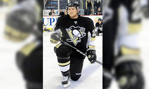 Matt Cooke kneeling on the ice, suspended multiple times for dangerous hits and head contact in NHL
