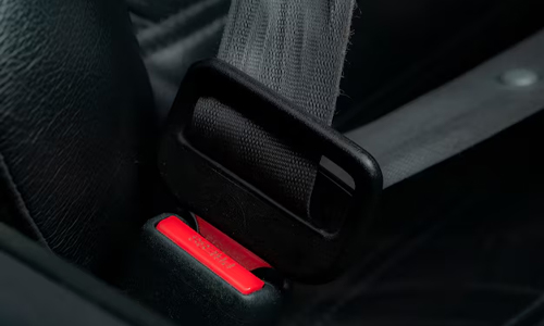 A person putting seatbelts