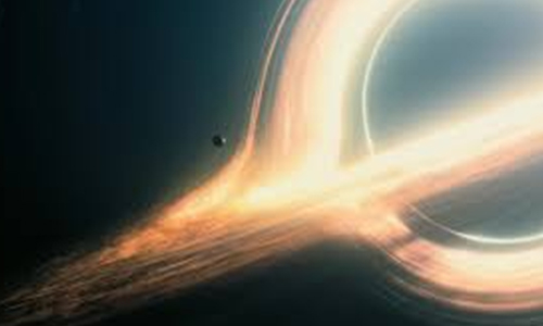 A glowing black hole with bright, curved light trails bending around it, showing how gravity warps space and time.